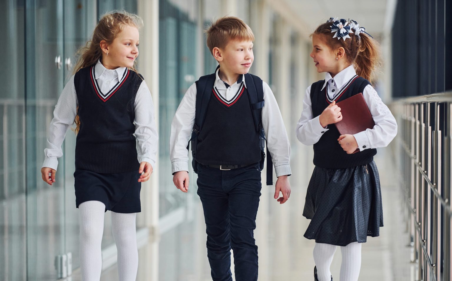 School kids in uniform together in corridor. Conception of education.